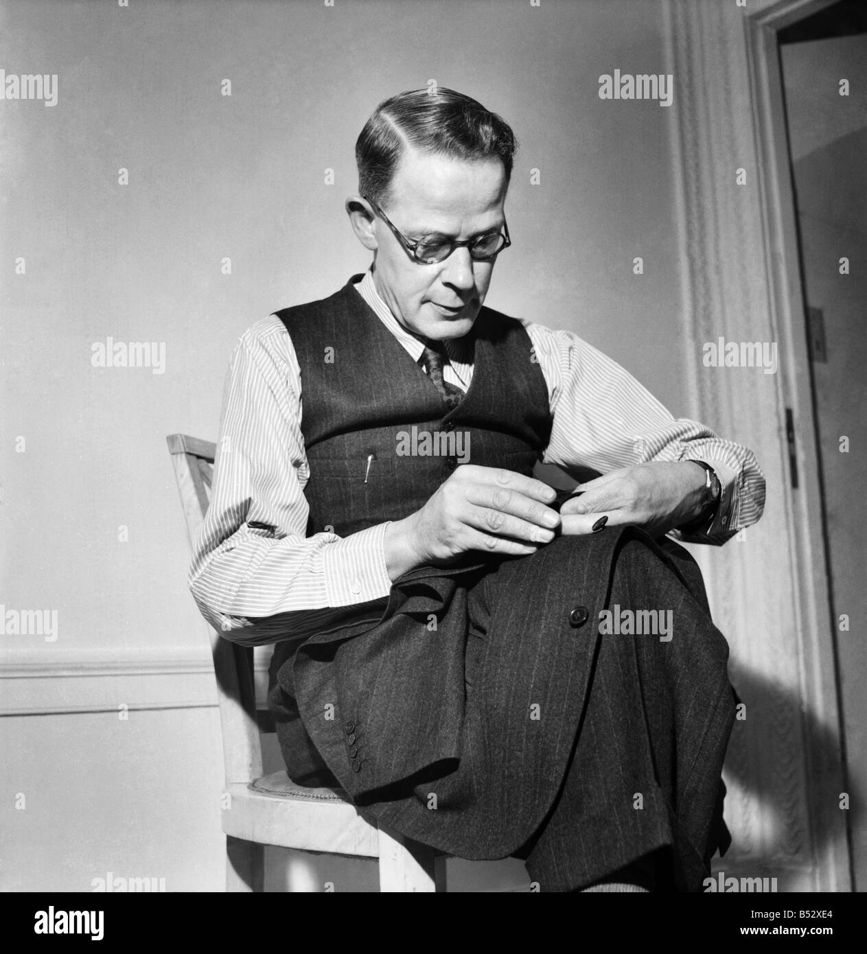 Man sewing on button&#13;&#10;Harry Leonard - Winner of National sewing Competition. June 1952 C3181 Stock Photo