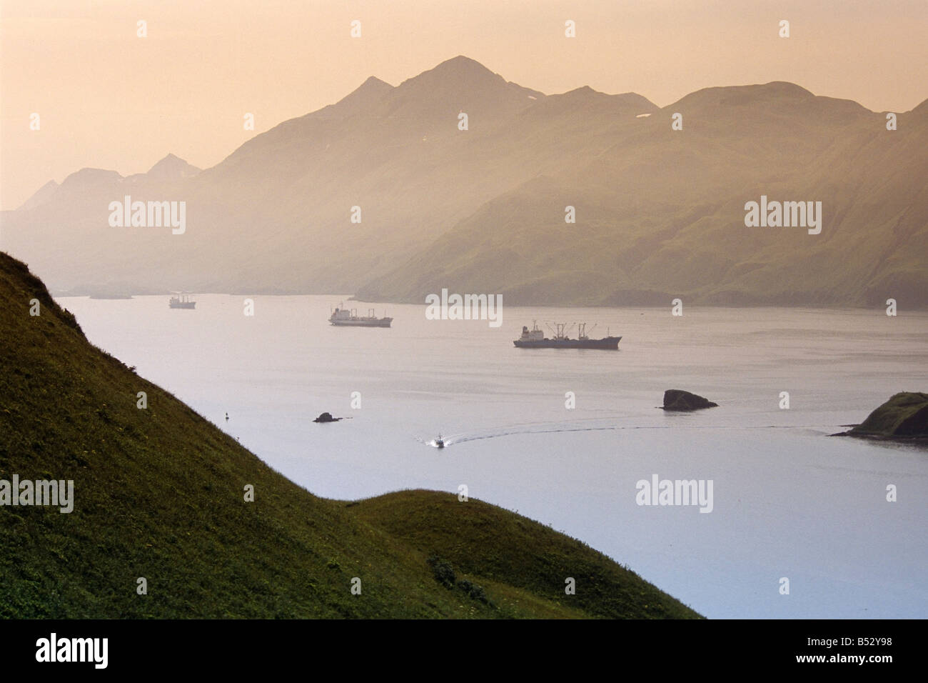 Commercial ships anchored in Captain's Bay at sunset Unalaska Alaska