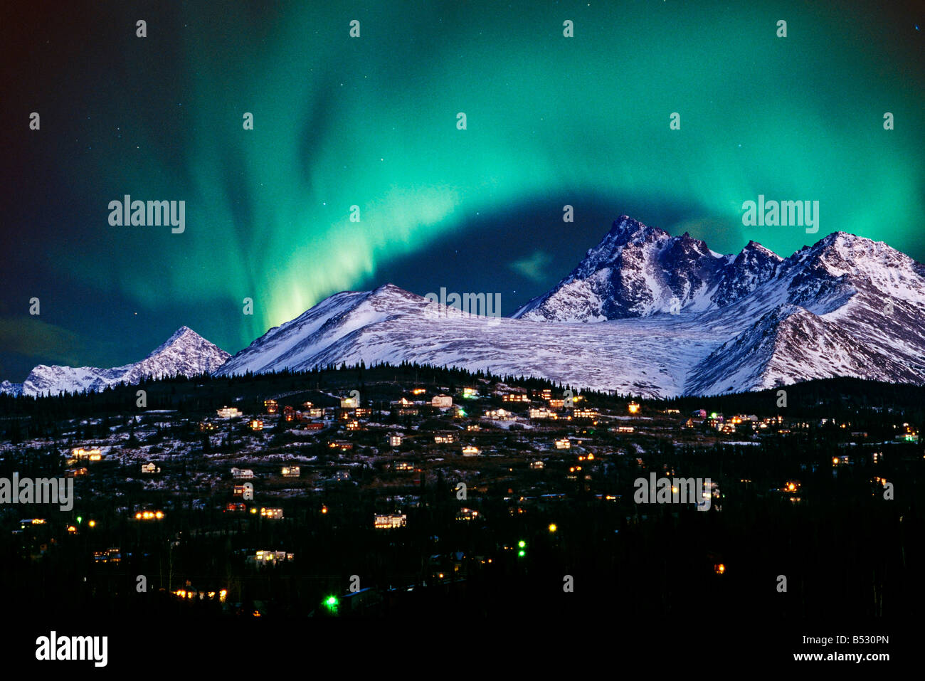 Aurora Borealis over hillside neighborhood & Chugach Mountains