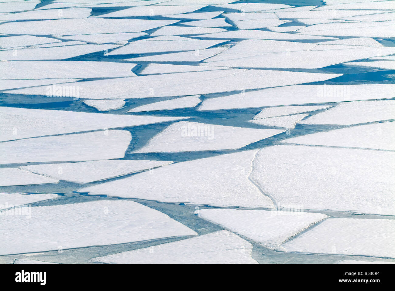 Winter ice layer on Portage Lake breaking up w/spring thaw Southcentral