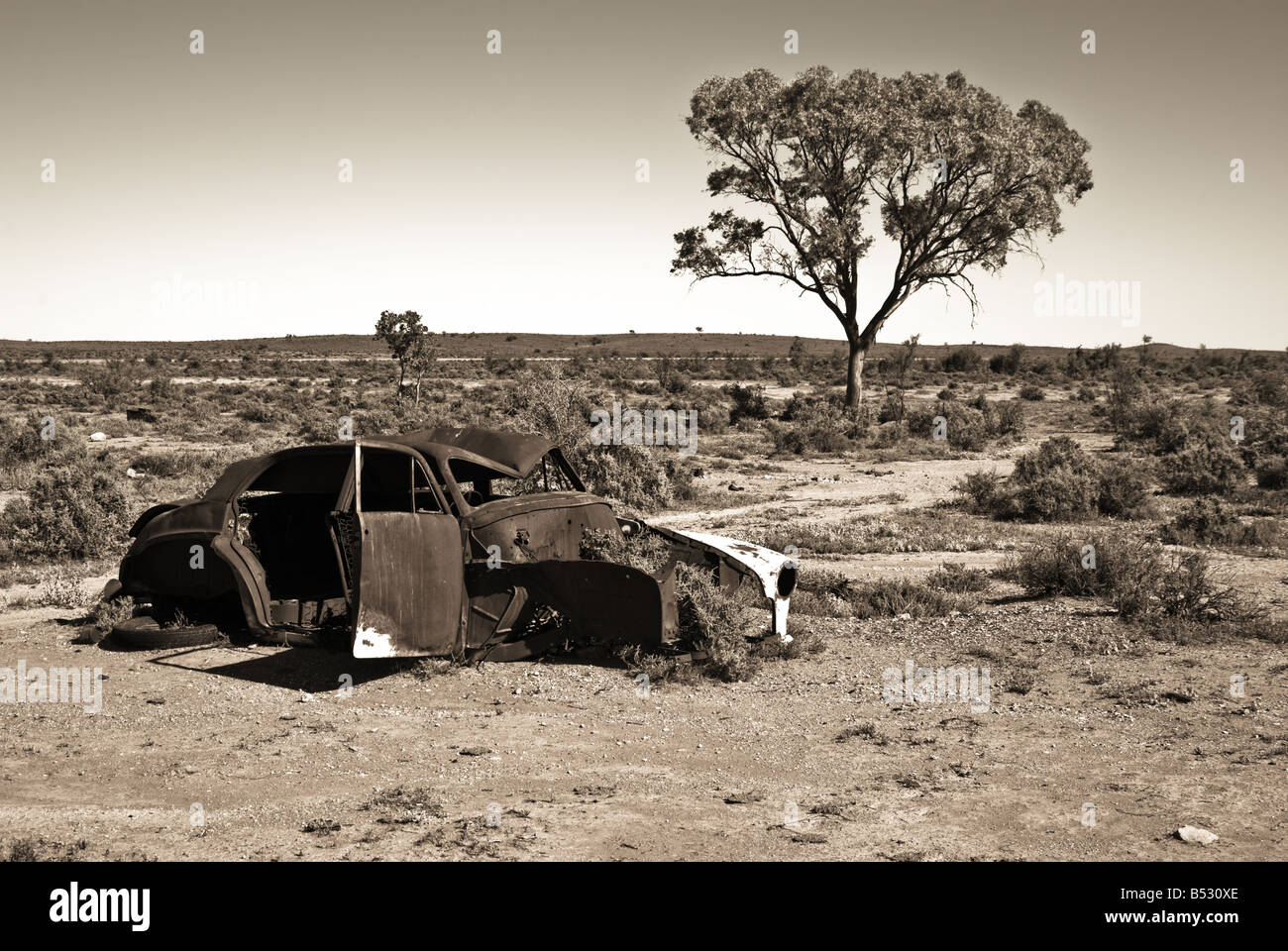 great image of an old car rusting away in the desert Stock Photo - Alamy