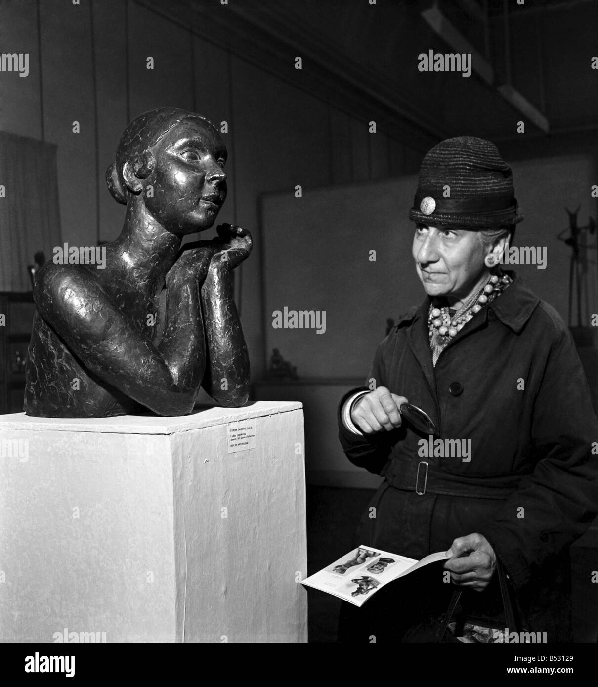 People examining pieces of art at the Exhibition of Sculpture at