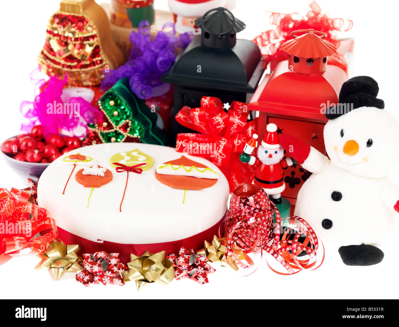 Decorative Iced Festive Christmas Cake, Colourful Seasonal Setting, With No People, Background Of Colour Lanterns Snowman Ribbons And Xmas Decorations Stock Photo