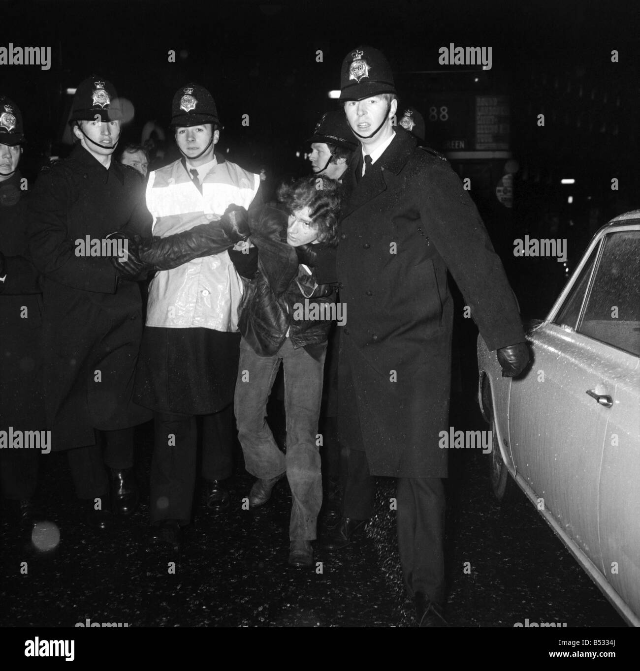 Bloody Sunday demonatration in Picadilly on the day victims of the shootings were buried in Londonderry.;A demonstrator is arrested by three policeman . February 1972 72-1093 Stock Photo