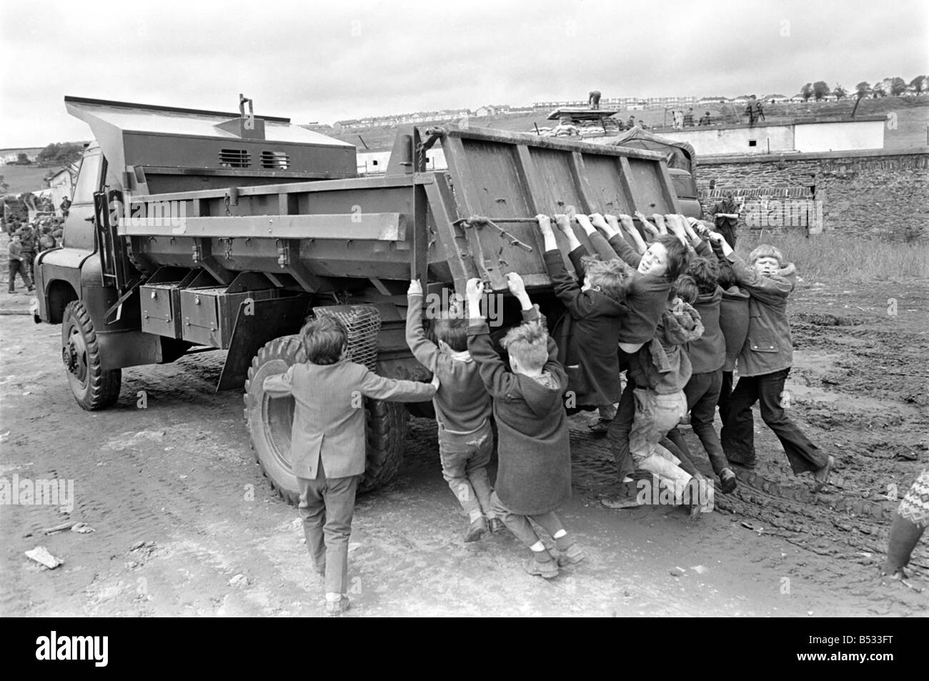 Northern Ireland June 1972. Children and soldiers play at the army base on the Foyle Road. The army were in the process of abandoning the camp. June 1972 72-7009-011 Stock Photo