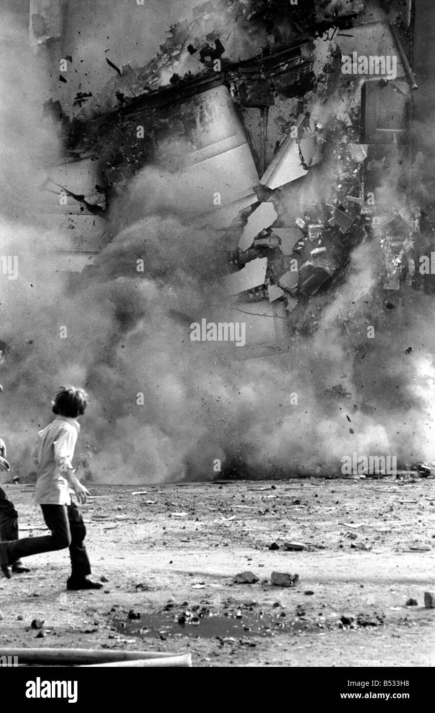 Derry fire in Northern Ireland. For one young boy - a front row seat as just one more building in his city is destroyed. This was the scene at 'aggro' corner in the Bogside as fire destroyed three more shop premises. 24 hours earlier a gelignite bomb had badly damaged the same premises. July 1972 72-7291 Stock Photo