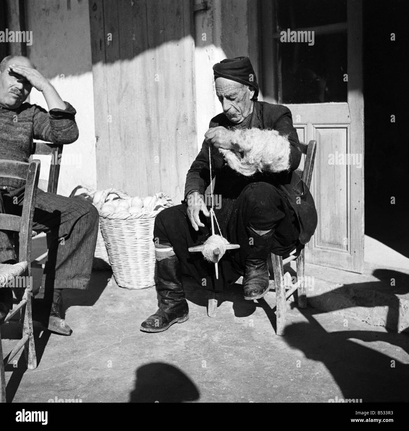 Old Greek Cypriot sitting in Greek cafe and making string an occupation  many old man seem to have. ;November 1952 ;C1103-003 Stock Photo - Alamy