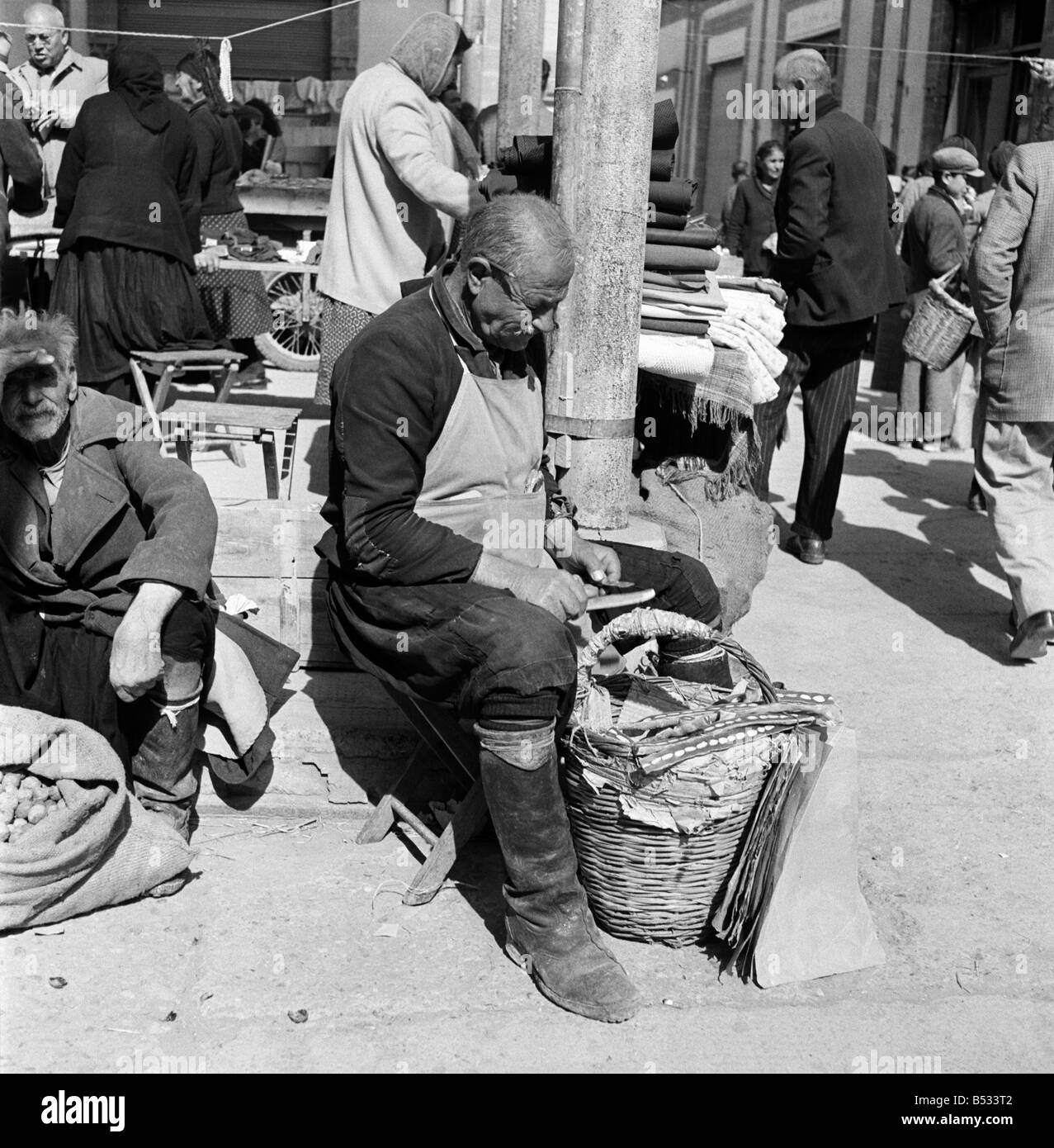 Traders at the Ladies Bazaar which opens every Friday in Nicosia, Cyprus,. The market sells items as diverse as lace, silk, embroideries, fruit and food. November 1952 C1105-006 Stock Photo