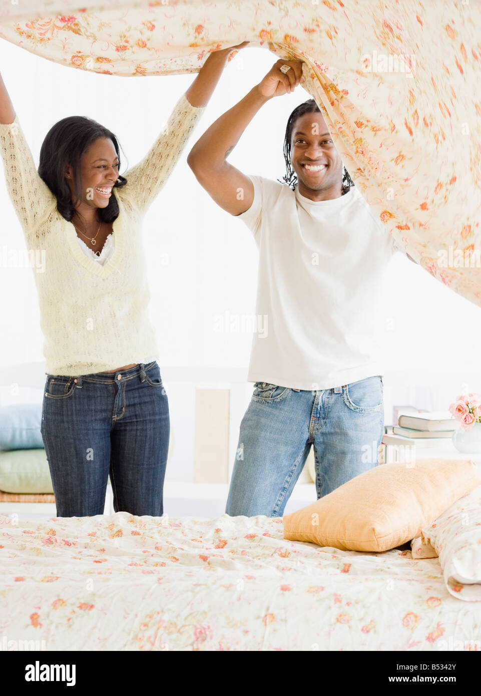 African couple making bed Stock Photo