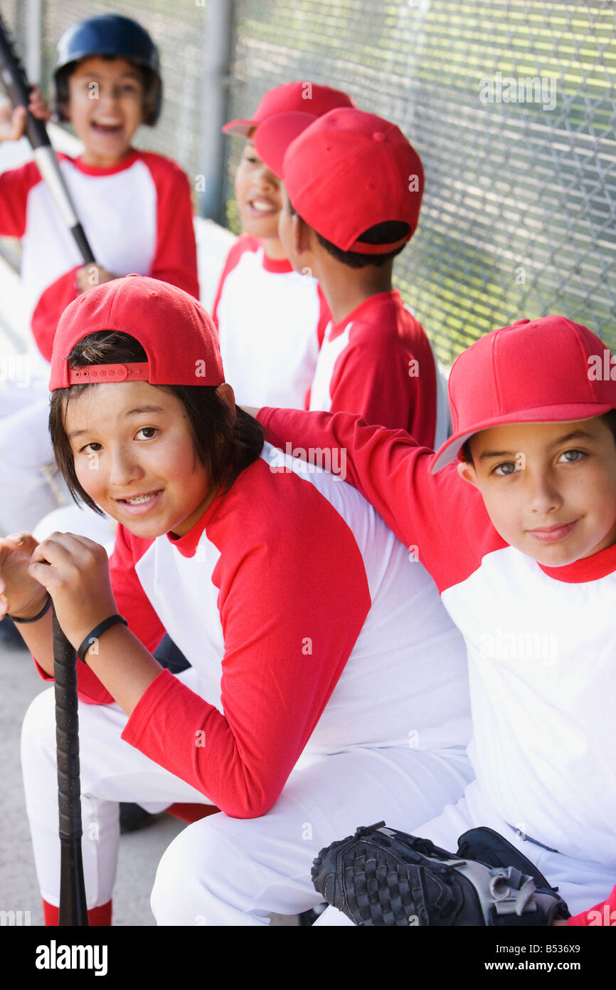 Multiethnic boys in baseball uniforms in dugout Stock Photo Alamy