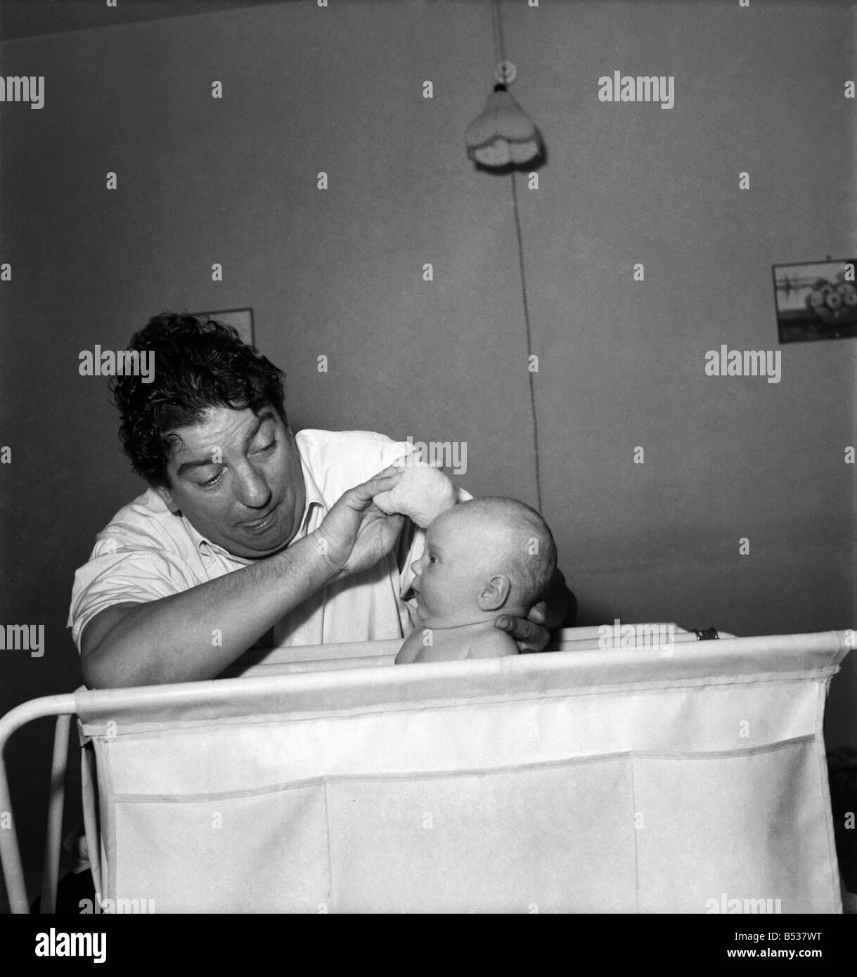 Sid Field with baby. September 1948 O14844-002 Stock Photo