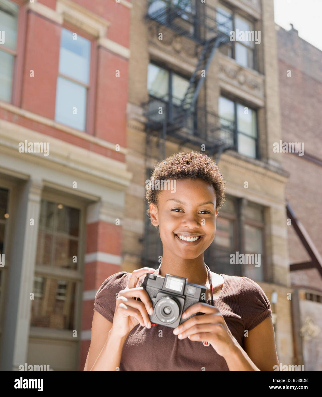African woman holding camera Stock Photo - Alamy