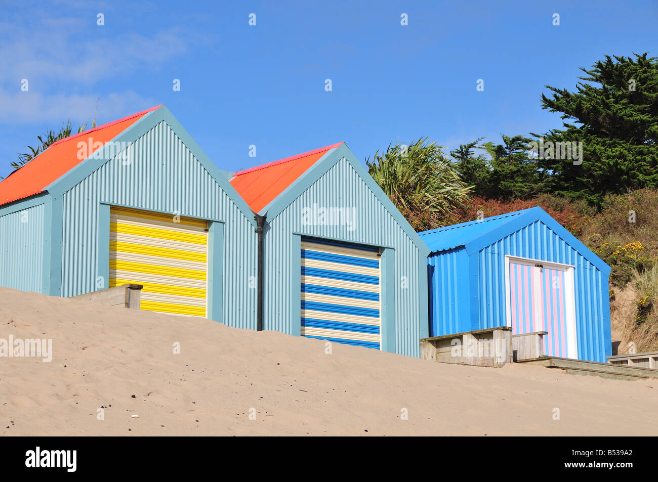 Brightly painted beach huts on Morfa Gors Beach Abersoch Llyn Peninsula Gwynedd Wales Stock Photo