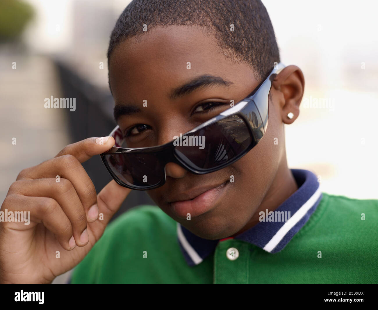 African teenage boy peering over sunglasses Stock Photo - Alamy