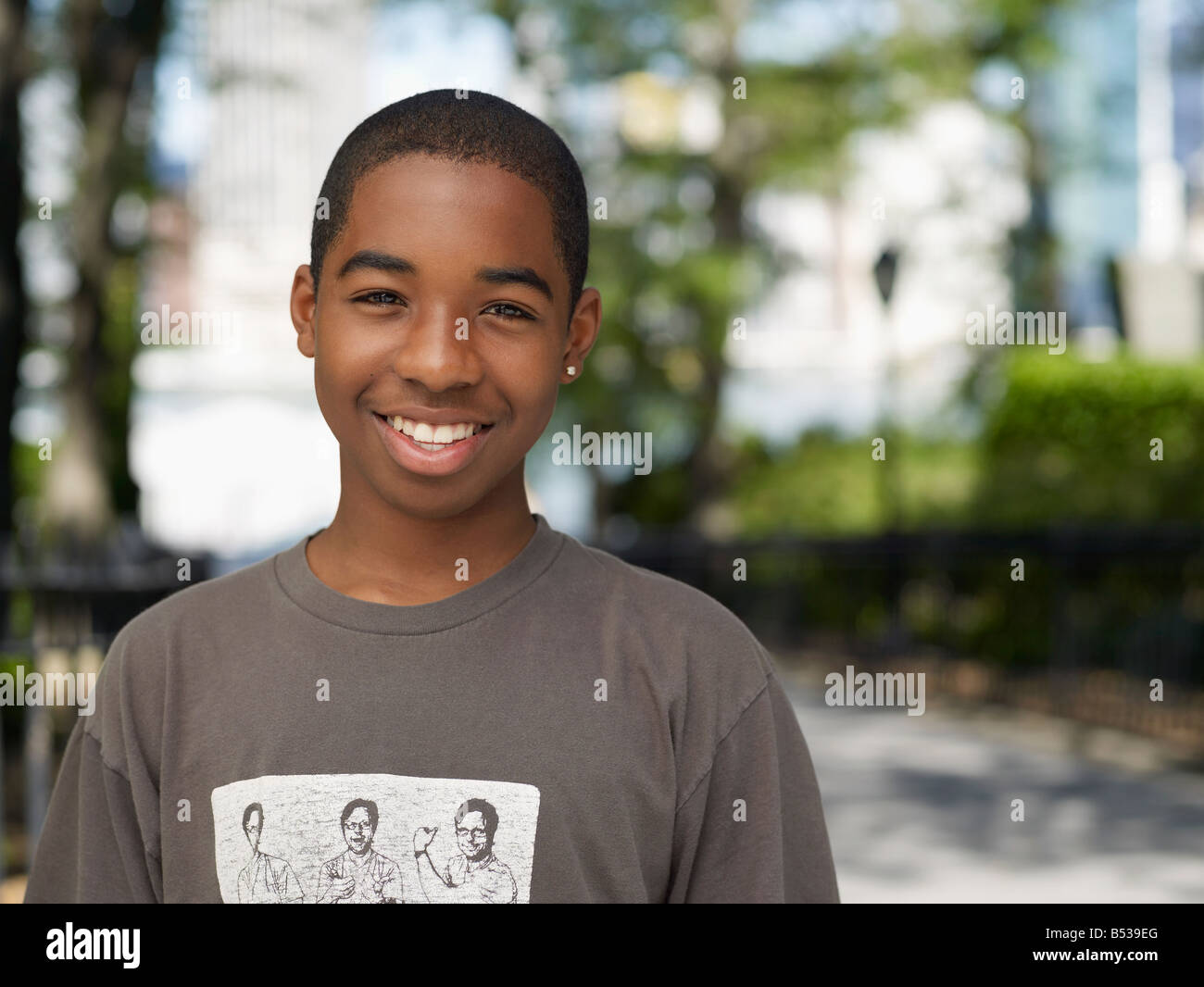 Smiling African teenage boy in urban park Stock Photo - Alamy