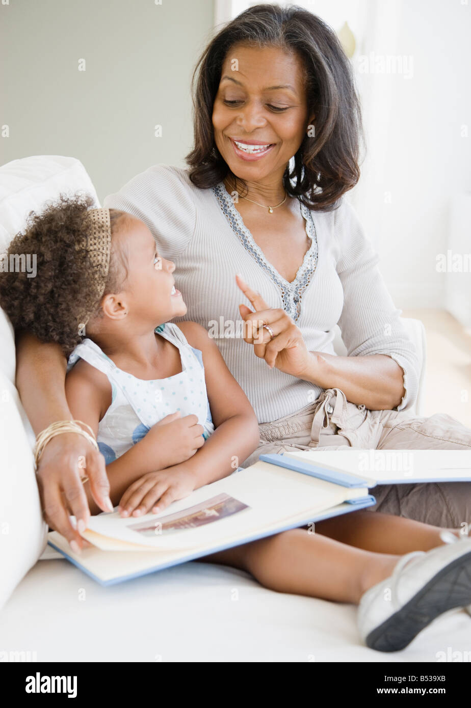 African grandmother looking a photo album with granddaughter Stock Photo