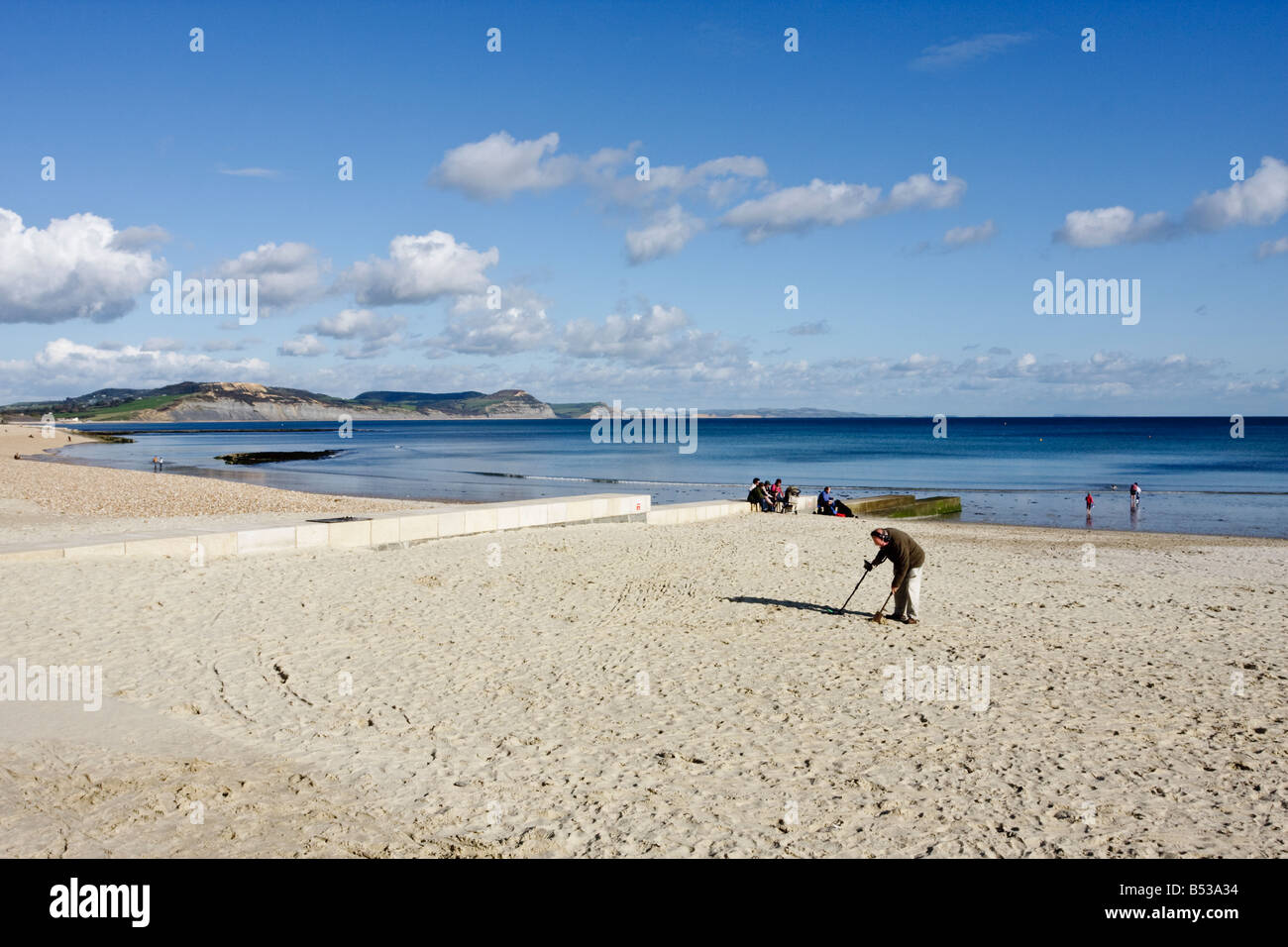 Metal Detectorist, Searching the Sand at Lyme Regis Stock Photo