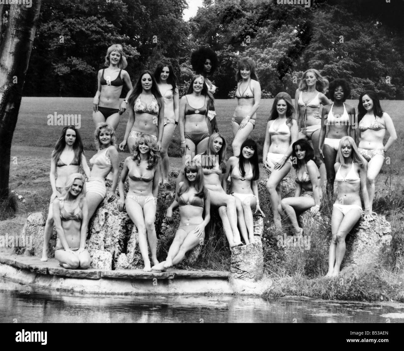 Fashion 1970s. ;25th anniversary of the bikini.  ;Group of models show off the two-piece swimming costume, sitting and standing Stock Photo