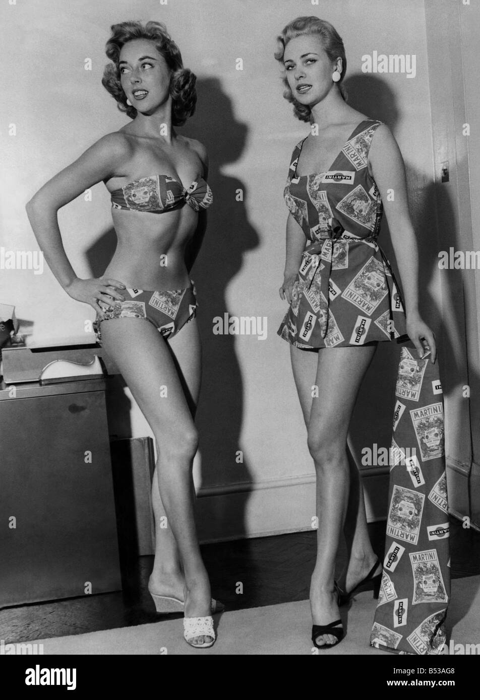 Clothing Fashion Beachwear. Model number 1271 bikini and play jacket with skirt in cotton martini print. The two models show the complete outfit that can be worn by one bather. August 1956 P017969 Stock Photo