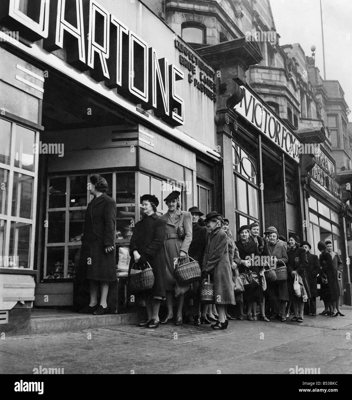 A queue is born. A million British housewives queue up each working day ...