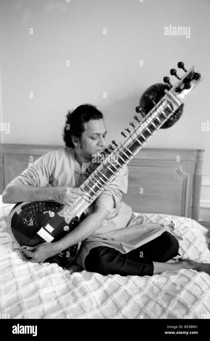Ravi Shankar playing the sitar in his suite at the Savoy Hotel Sitting on bed Music Musician