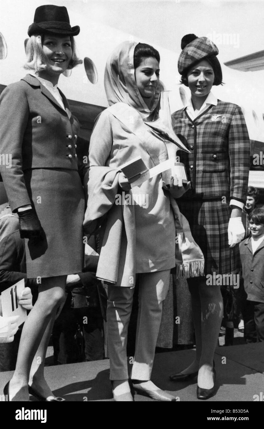 Fashion 1960s. Such prizeworthy pyjamas. The judges decided that Nabila Jilani, the girl in the middle, was the absolute cat's pyjamas. And they awarded her the Miss Air Fashion sash on Thursday (9-5-68). Of course, Bail's pyjama-style trousers had something to do with it. So did the rest of her beige uniform, designed by Pierre Cardin. Nabila, a 23-year-old hostess with Pakistan International Airlines, won the title at the opening of the Biggin Hill Air Fair in Kent. Second was Austrian Airlines hostess Gerlinda Skalnik, on Nabila's left Stock Photo