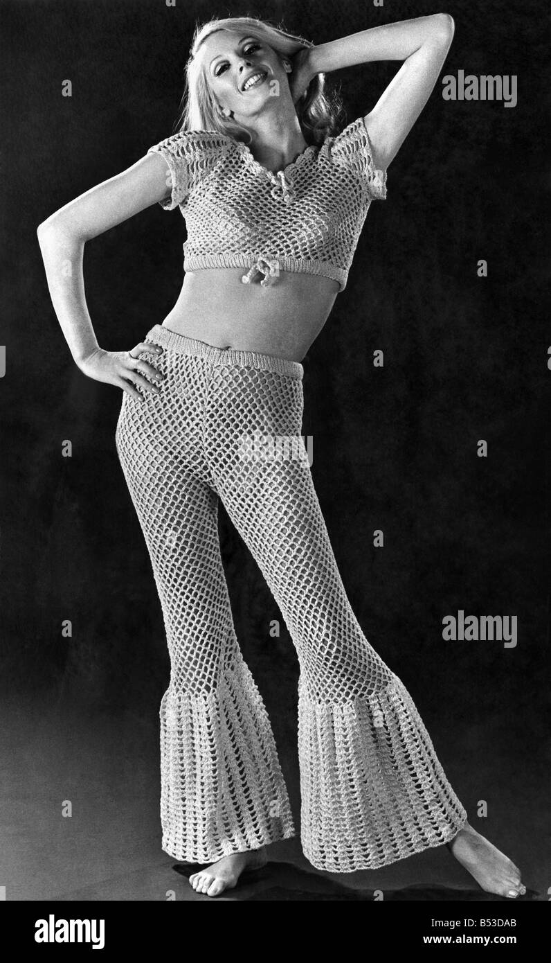 Seaside seethrough trouser suit is as good as air-conditioning. Pants have shell-stitched bell bottoms. Short-cropped top has matching shell pattern sleeves. ;April 1970 ;P017599 Stock Photo