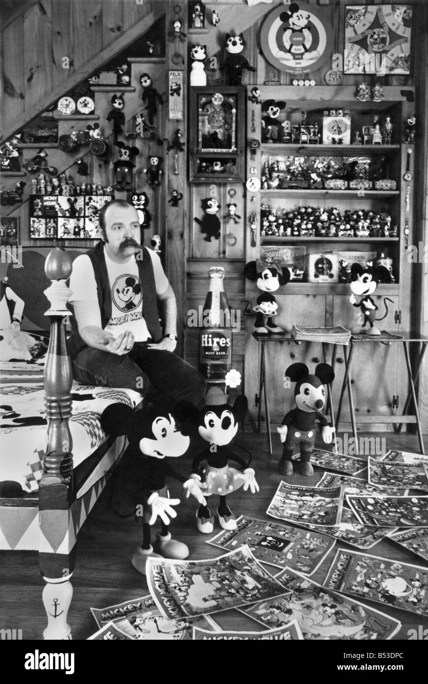 Collections. Mickey Mouse mania. ;Assistant Professor John Fawcett at his home - surrounded by Mickey Mouse in many shapes and forms. ;Disney, toys, bed cover, posters, magazines. ;March 1970 P017783 Stock Photo