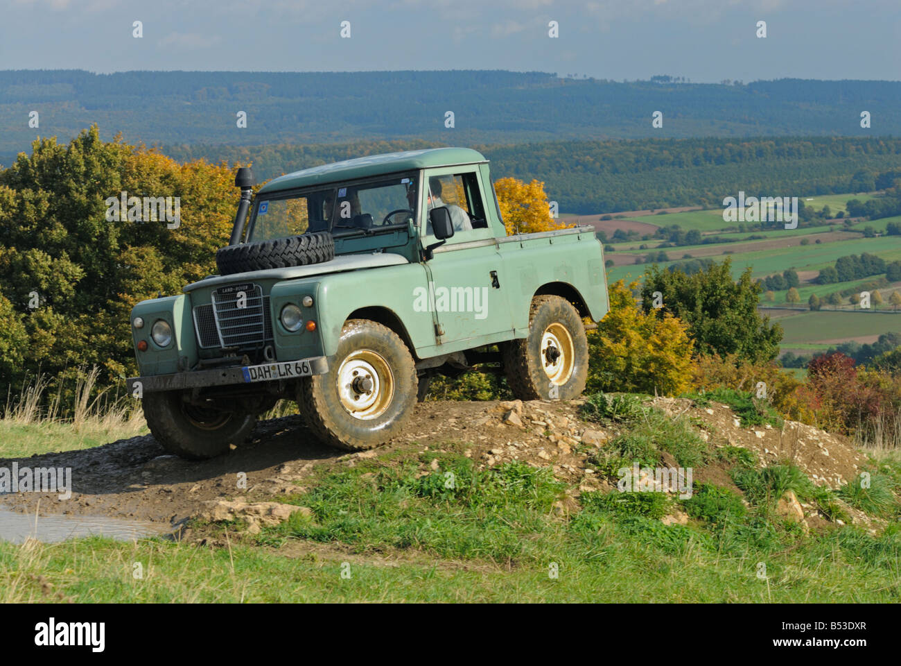 Light green 1970s Land Rover Series 3 SWB Truck Cab on a forest track in the Weserbergland. Stock Photo