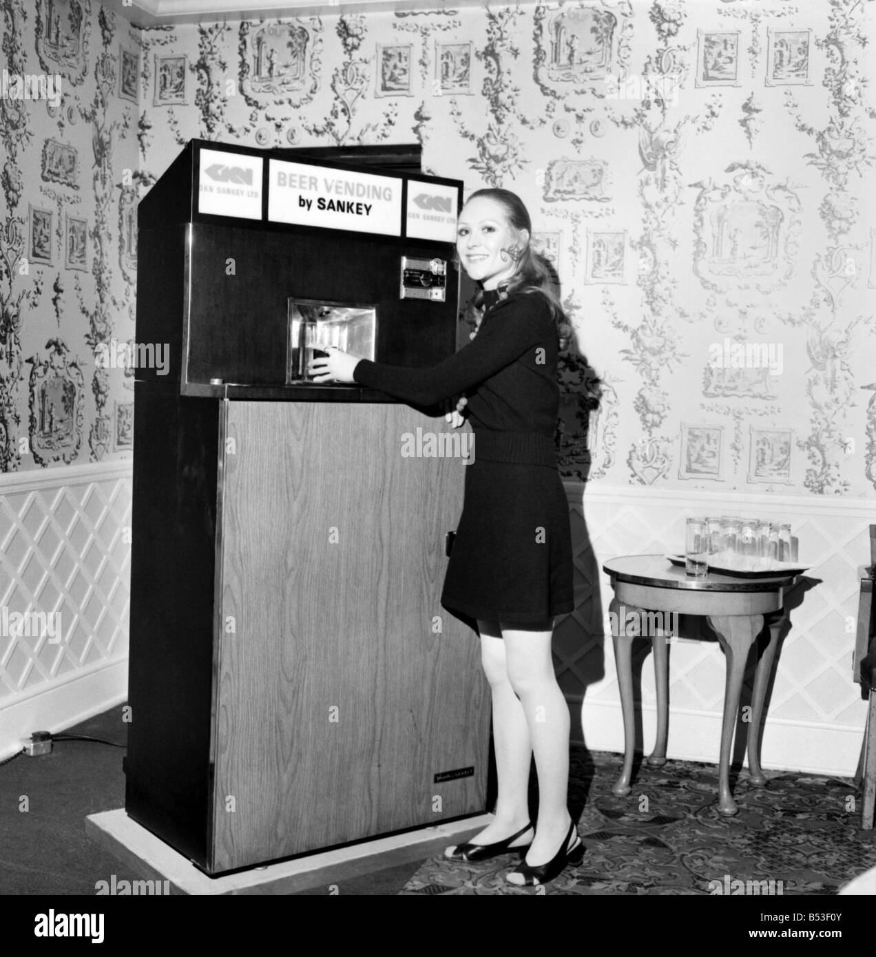 Inventions: Britain's first automatic refrigerated draught beer vending machine was demonstrated by the Brewery Division of GKN Sankey Ltd., of Bilston Staffs, at Quaglino's Bury Street, London. Woman with the front of the autobarmaid open showing the interior. December 1969 Z11595 Stock Photo