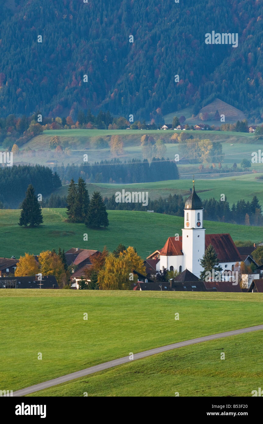 Church tower rises above village of Zell during autumn, Allgäu region, Bavaria, Germany Stock Photo