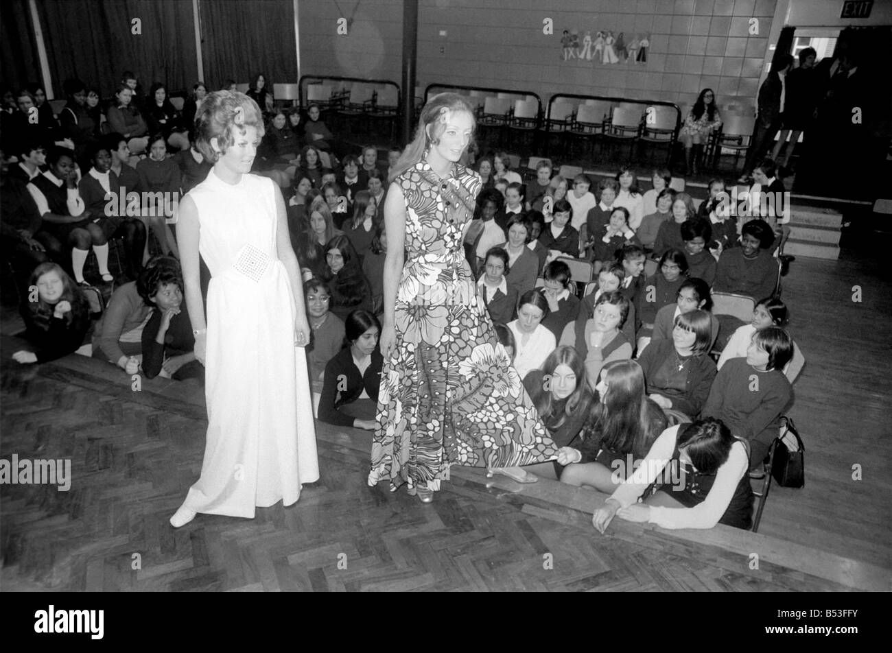 Fashion Clothing. Today, girls in Tower Hamlets schools saw their own fashion show at Tower Hamlets school in Richard Street, E. 1. The show was presented by a well-known fashion house, Carnegie Models, Ltd., and arranged by the local ILEA careers office as part of an extensive programme of talks. Angela Taylor (23) from Lancaster Gate, modelling a white evening dress in Ceylon washable jersey - price £16., and Jenny Knox from Hounslow, modelling a multie-printed culotte in Tricel jersey - price £13. 5. Od. December 1969 Z11835-002 Stock Photo