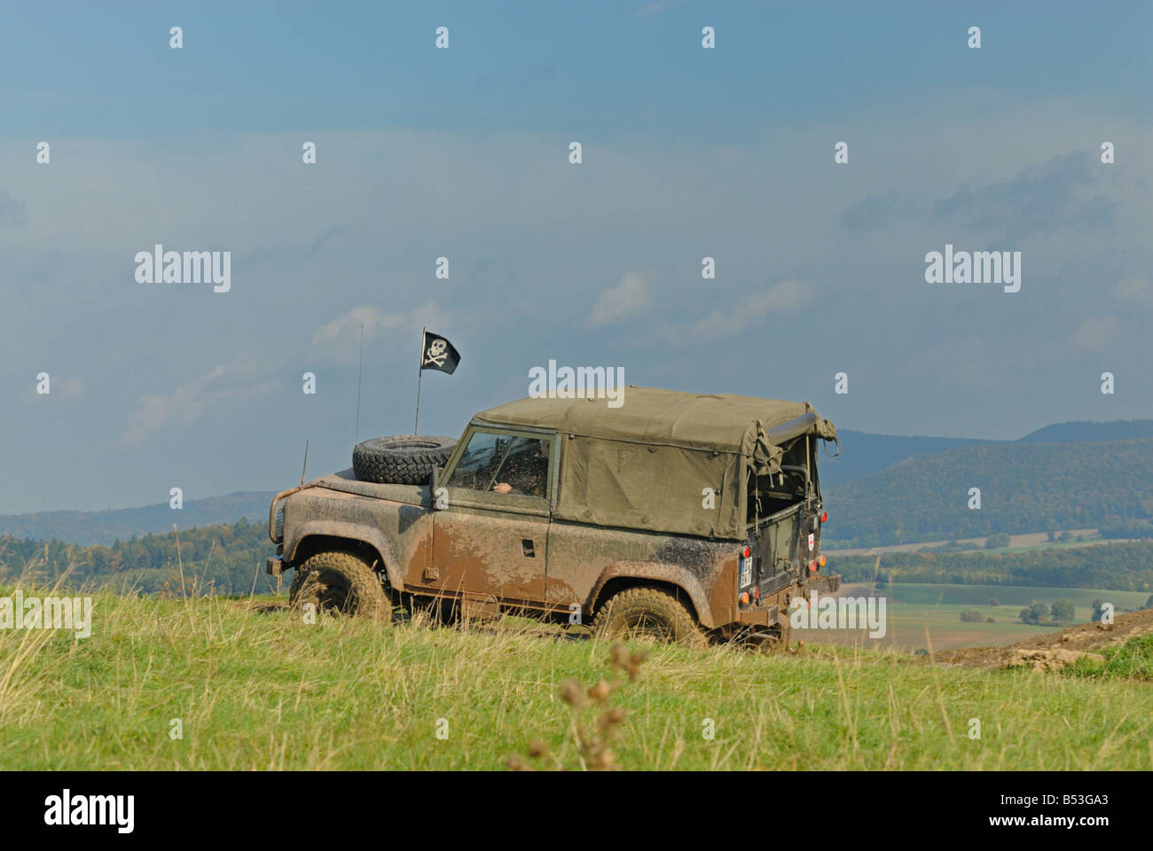 Ex-military 1990s Land Rover Defender 90 softtop on a forest track in the Weserbergland. Stock Photo