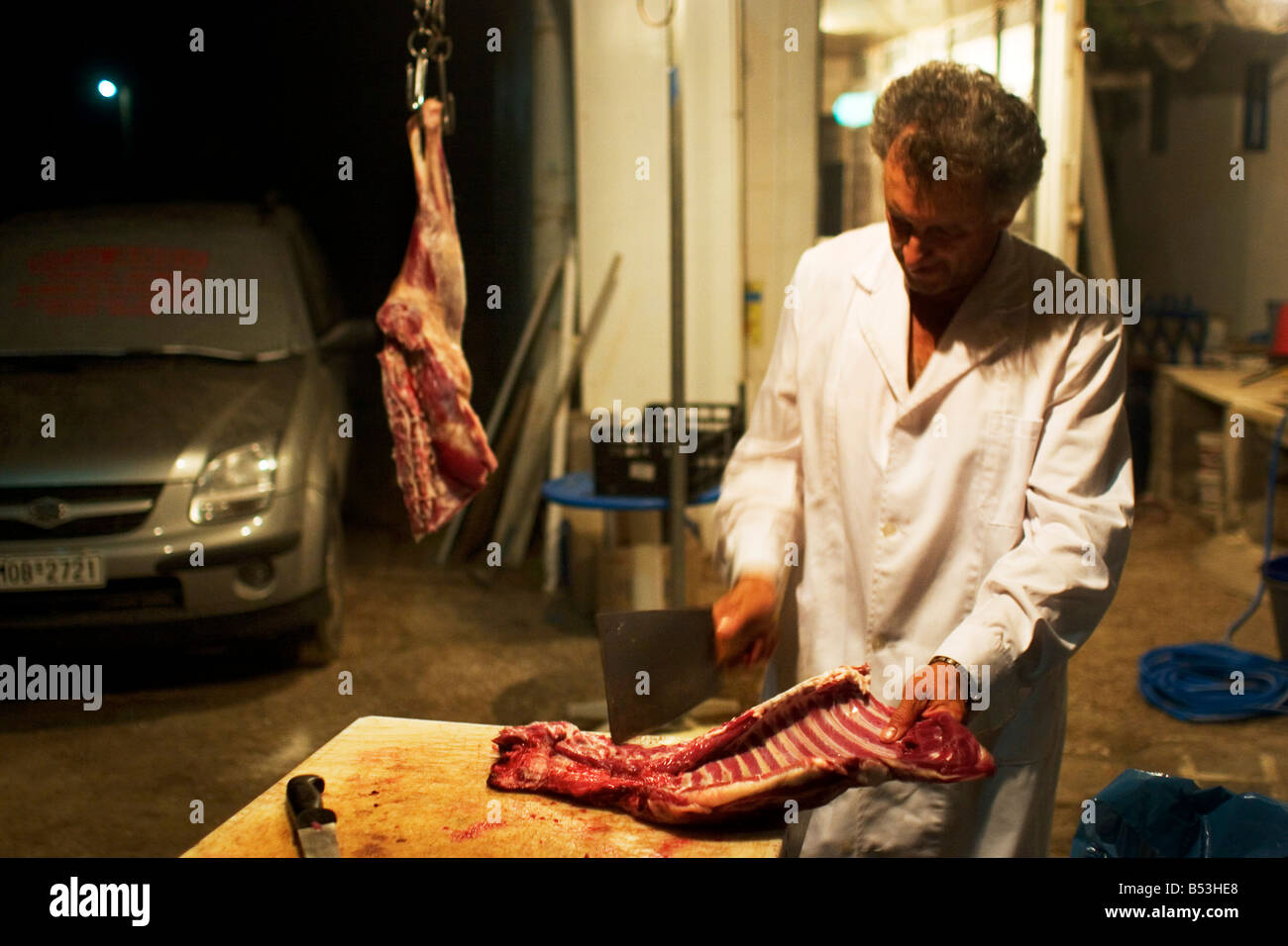 Hotel og restaurationsejer Yannis har slagtet geder og goer koedet klar til kommende menuer  Stock Photo