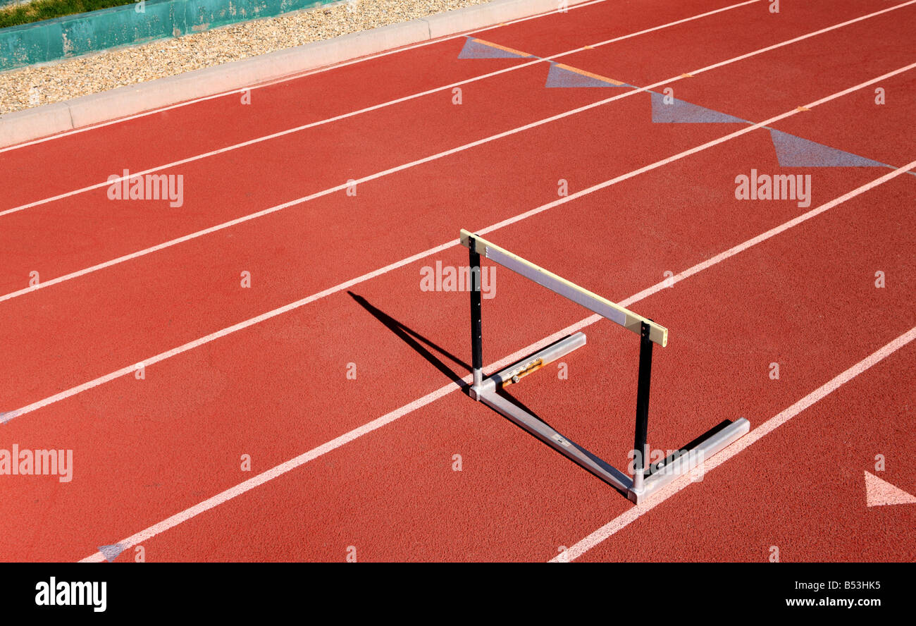 Single hurdle on red sports track Stock Photo