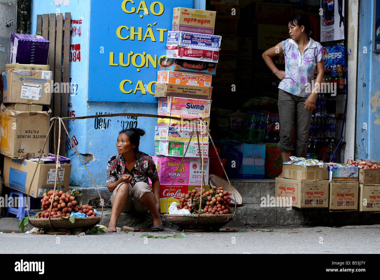 Sales woman traditional shop Hanoi Vietnam South East Asia Stock Photo