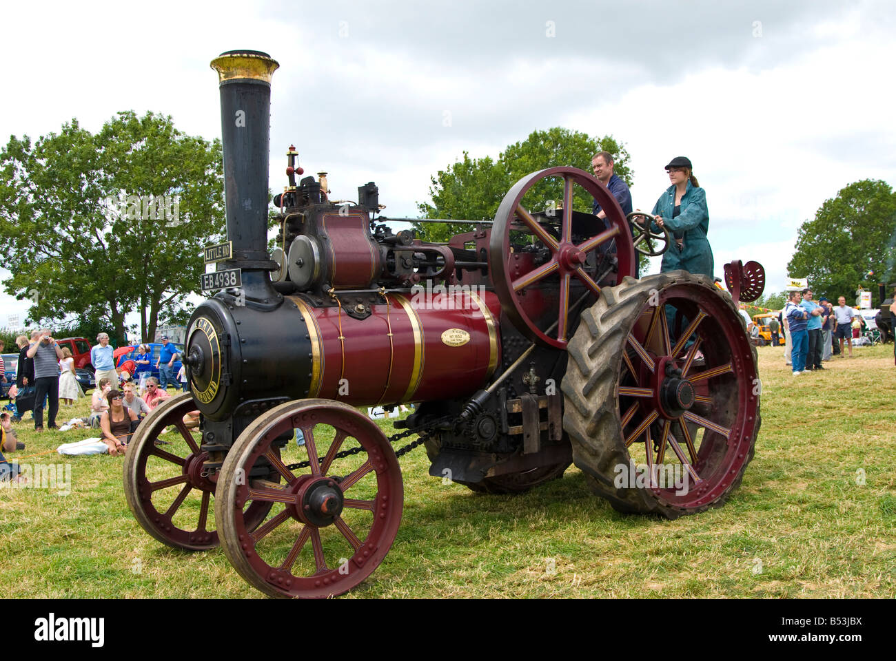 A man and woman drive and display their steam traction engine at Bloxham Vintage Vehicle Show. UK. Stock Photo