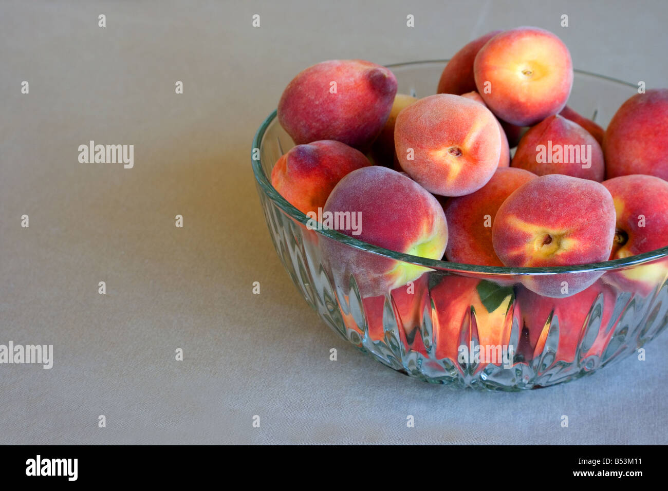Fresh peaches in a crystal bowl Stock Photo Alamy