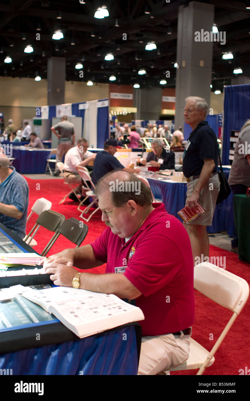 Stamp collector peruses stamps for sale at a booth at the American Philatelic Society stamp show in Hartford Connecticut Stock Photo