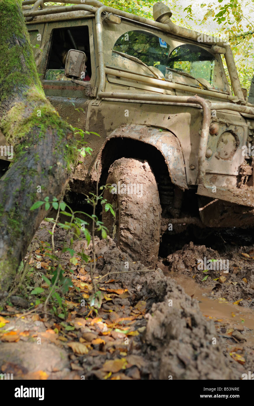 Muddy Land Rover Defender 110 stuck on a forest track in the Weserbergland. Stock Photo
