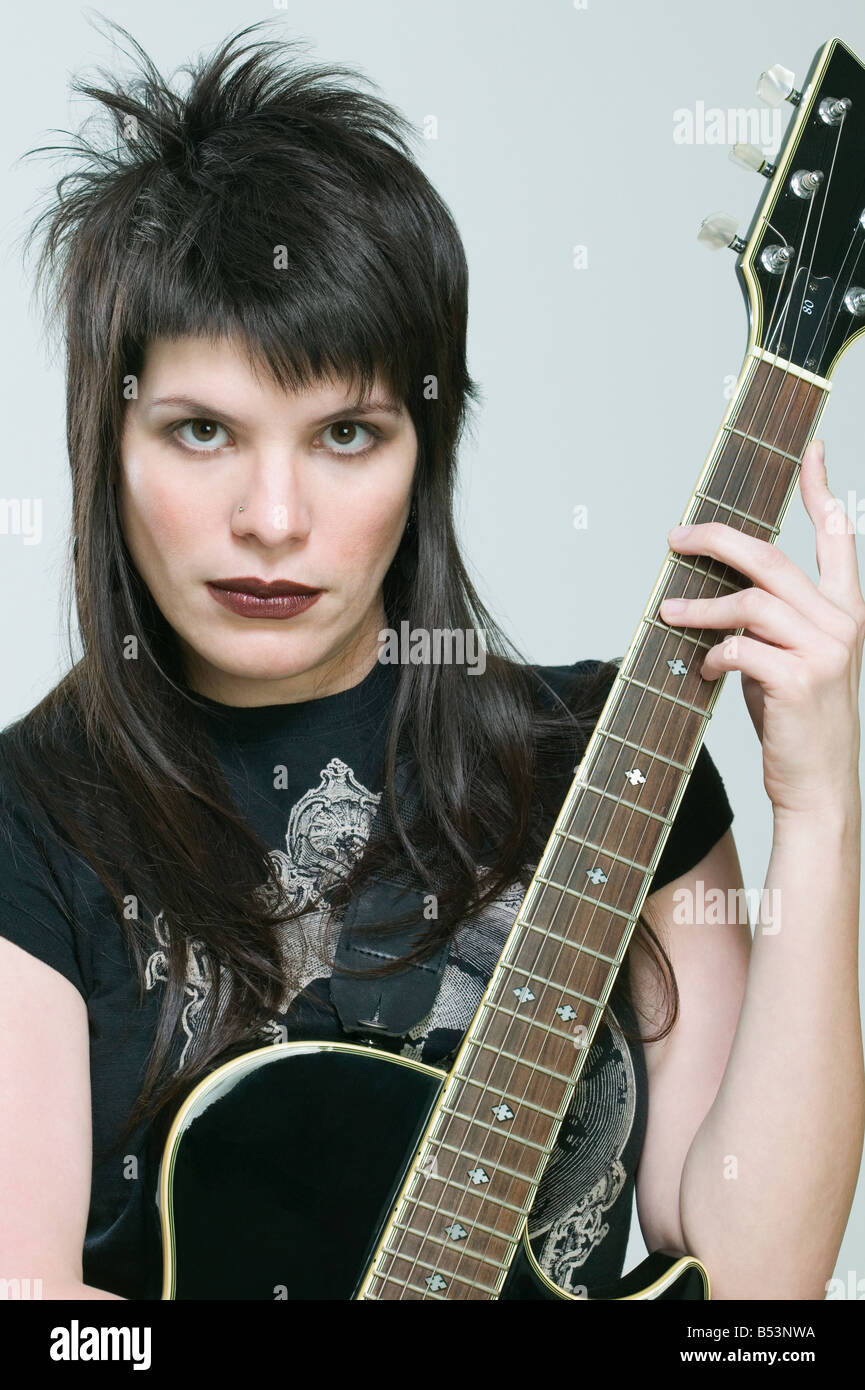 Hispanic woman holding guitar Stock Photo - Alamy