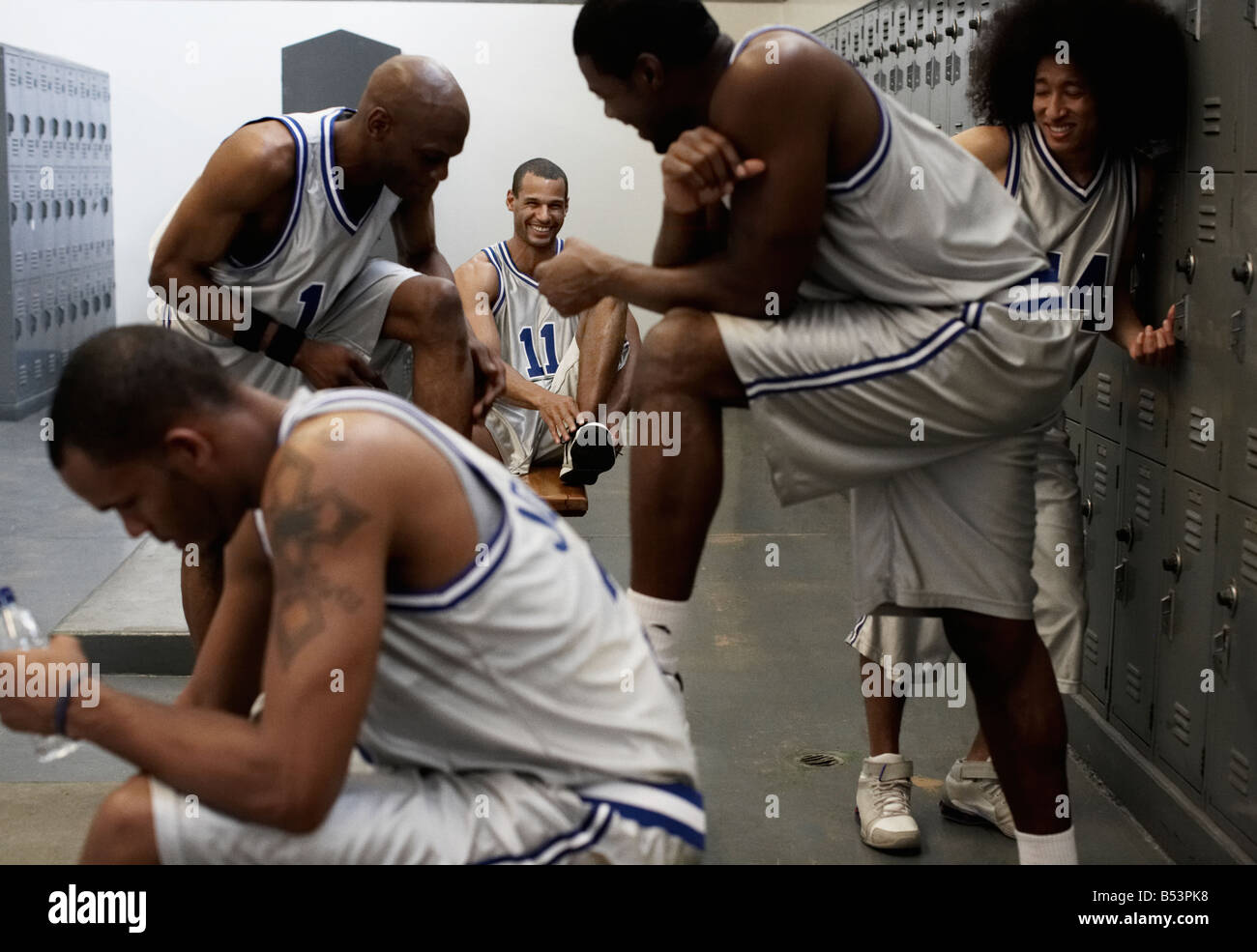 Multiethnic basketball players dressing in locker room Stock Photo Alamy