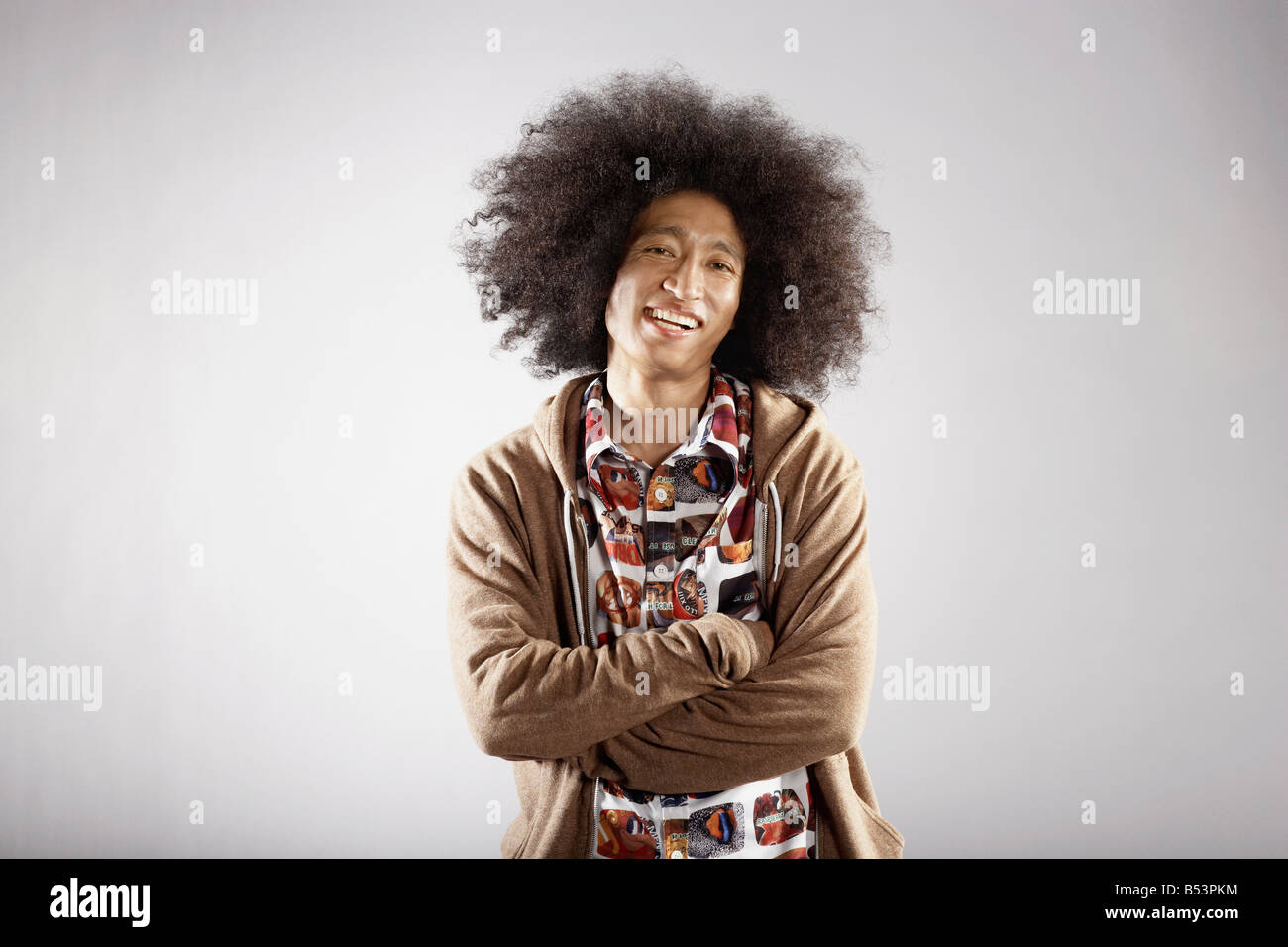 Confident mixed race man with arms crossed Stock Photo
