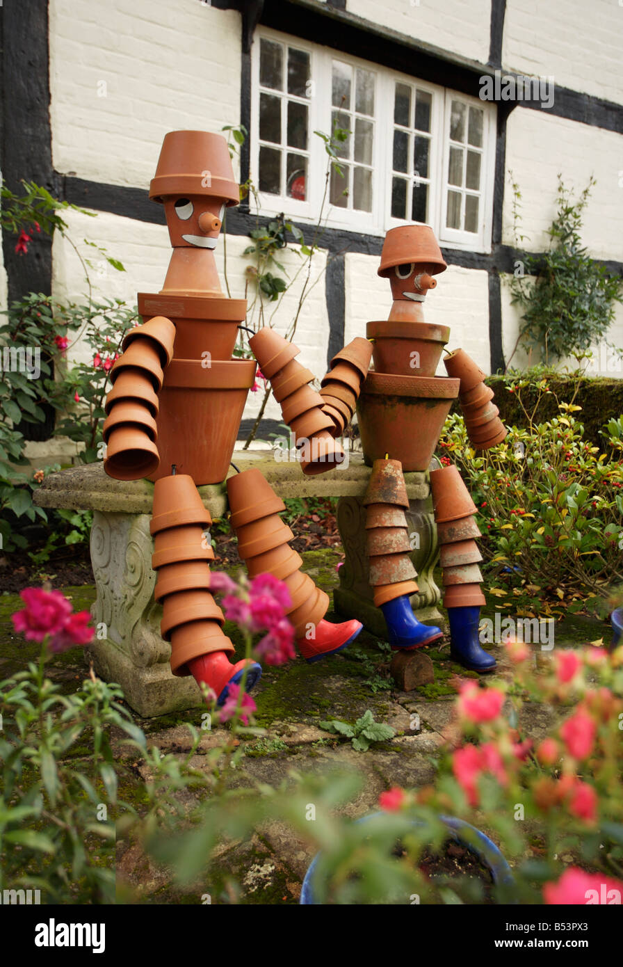 Flower Pot Men' in a cottage garden in Shere, Surrey Stock Photo - Alamy