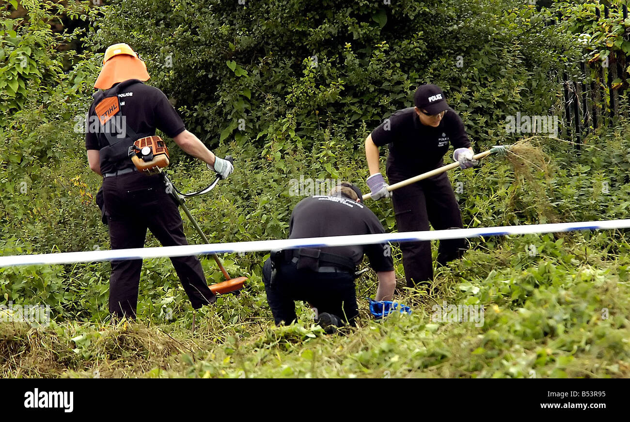 Police search teams scour the woodland at the back of The Fir Tree Pub