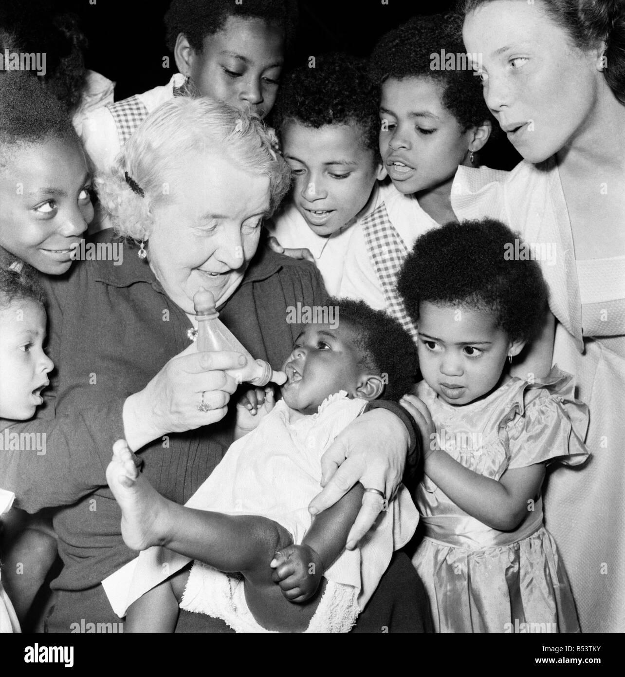 Foster Mother, Mrs. Ada Wheeler seen here bottle feeding one of her
