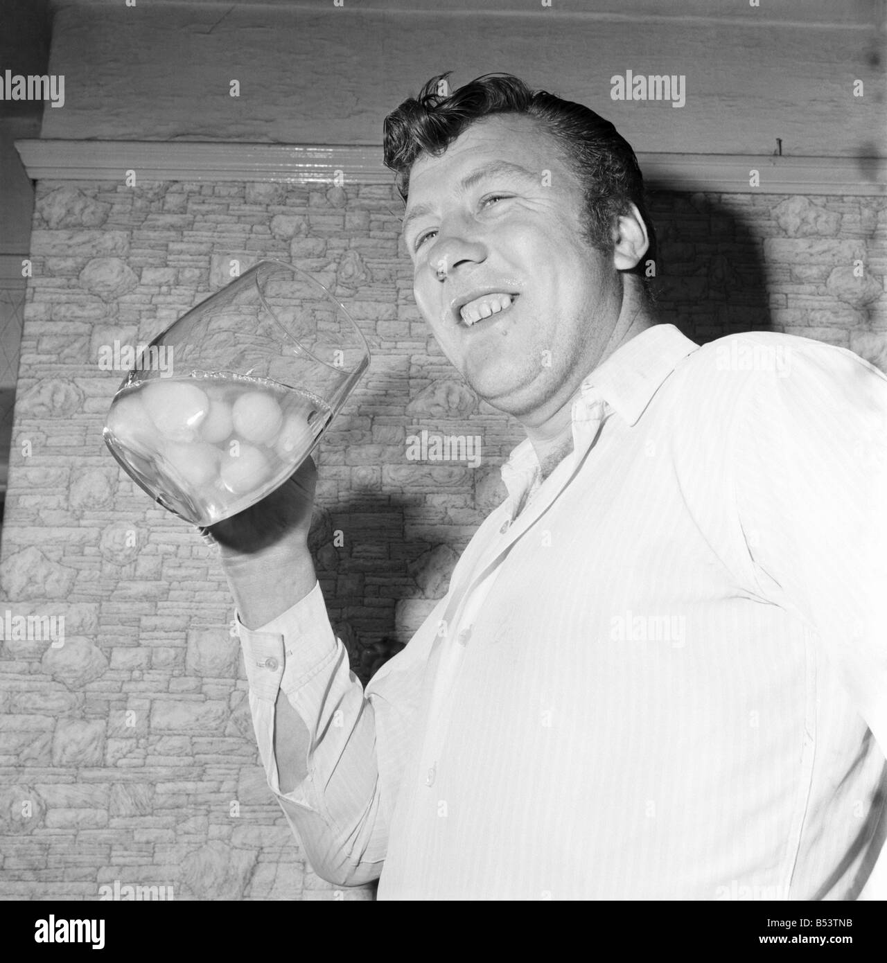 Where eggs are concerned sixteen stone steelworker Bob Irwin takes some beating. He eats them raw by the dozen as a starter to his mid-day meals. Here he is about to swallow twelve fourpenny ones in a big glass. ;November 1969 ;Z10597 Stock Photo