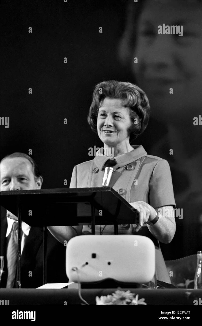 The Institute of Directors annual conference at the Albert Hall, more improperly known as 'The Picnic' from the practice of serving lunch in picnic boxes to the 3,000 odd, directors who attend, was addressed today by such diverse speakers as Barbara Castle, Ronald Reagan, Governor of California, Ian McLeod and John Betjeman. Barbara Castle speaking at the conference, and behind her a giant screen projects a more than life size picture of her in action Stock Photo