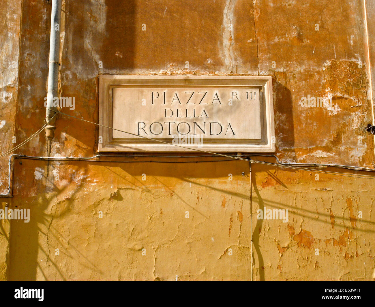 Details of rust coloured old building wall and window shutters at Piazza della Rotonda near