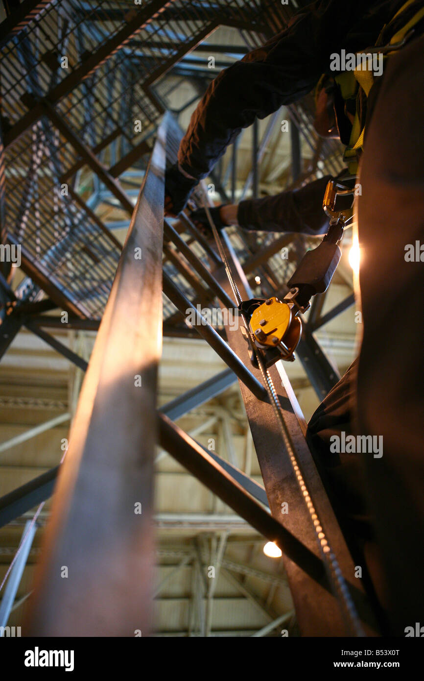 Person using safety equipment on a pylon tower Stock Photo Alamy